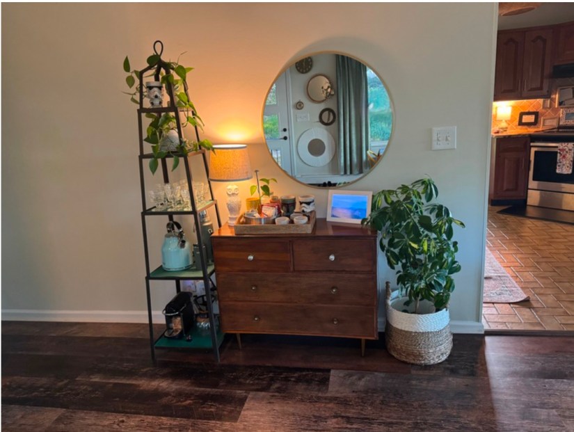 A little vignette made up of a vintage dresser, mirror, and etagere.