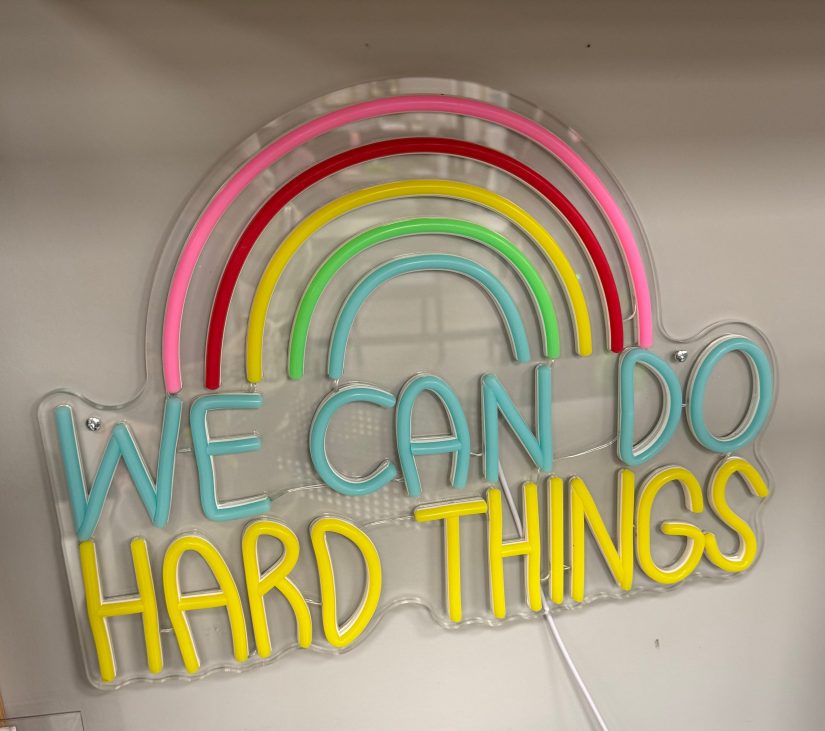 unlit neon-style sign saying "WE CAN DO HARD THINGS"